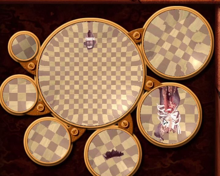 A Lens Bender puzzle in the original game: a large central lens with a chequered background, surrounded by six smaller lenses holding pieces